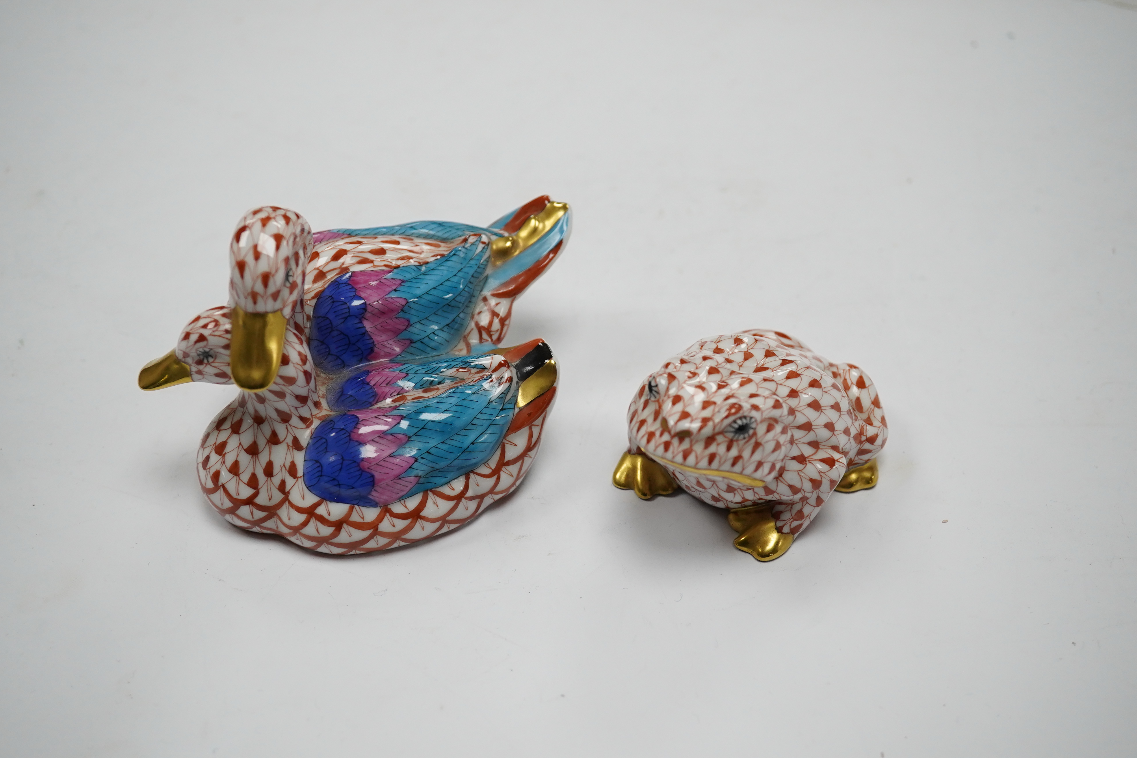 Two porcelain Herend red scale animal figures comprising a duck group and a toad, largest 11cm wide. Condition - good